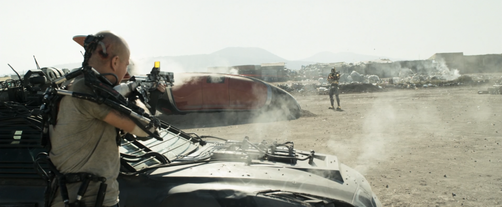 Matt Damon as Max lets rip on a droid in Elysium.